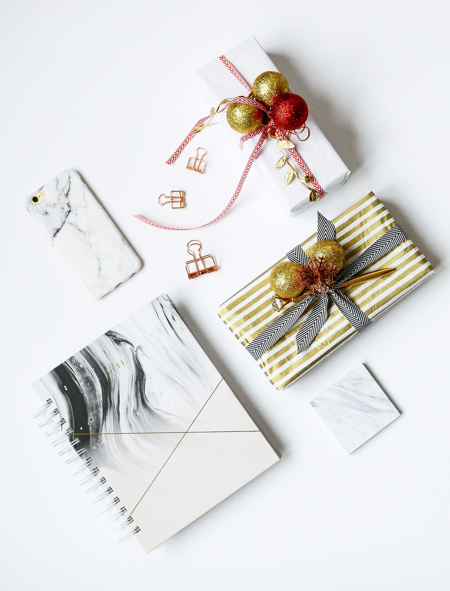 several assorted-color present boxes and notebook on table